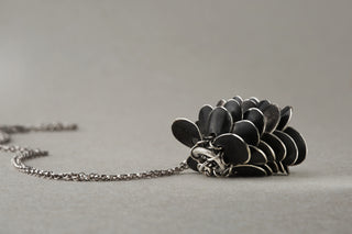 Oxidized silver scale mail pendant necklace detail showing kinetic movement — Pine Cone by Auri Jewelry