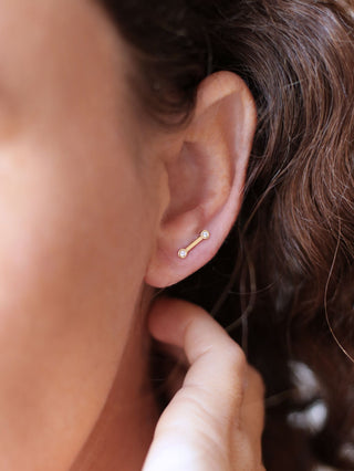 the denna stud jewelry in a lobe piercing