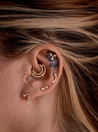ear with many piercings jewelry made in 14k gold