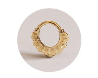 14K gold septum clicker ring in yellow gold, named Winter is Coming, displayed on a neutral background