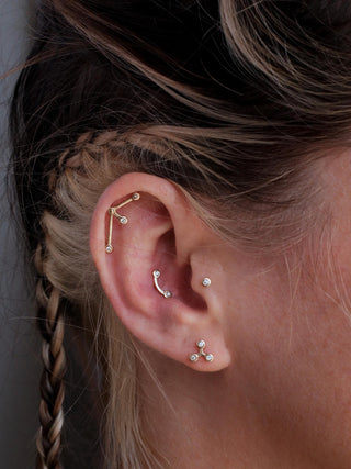 conch stud in 14k gold with 2 diamonds