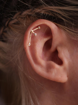 helix piercing with moving bars in 14k gold and diamonds 
