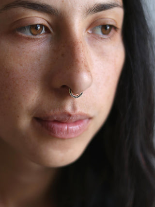 septum ring with a row of black diamonds